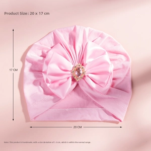 Pink cotton baby turban with large satin bow and central rhinestone detail 20x17cm
