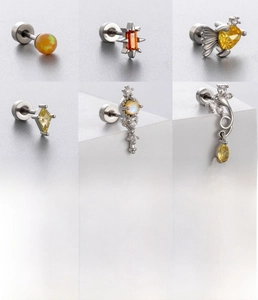 Detailed grid of titanium steel ear studs featuring yellow opal and zircon designs