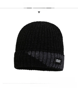 Close-up of thick ribbed knit texture and GD fabric patch on the winter beanie hat