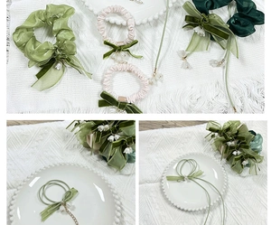 Detail of silk hair scrunchie with lily of the valley charm and pearl beads