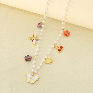 Detailed view of pearl necklace featuring butterfly, bee, and floral enamel pendants