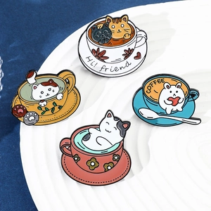 Detail view of 4-piece set of cartoon cat coffee cup enamel brooches on a white tray