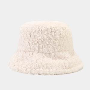Close-up of beige sherpa bucket hat showing thick fluffy texture and minimalist design