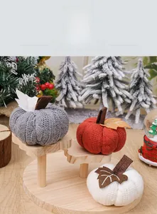 Macro detail of knitted pumpkins with cable texture and felt stems for autumn decor