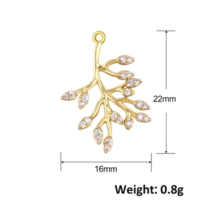 Macro shot of 22mm x 16mm golden leaf pendant with white zircons weighing 0.8g