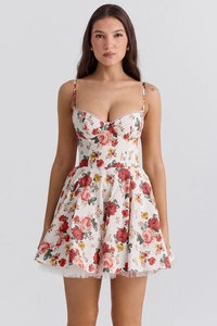 Close-up of floral summer dress featuring thin straps and delicate mesh hem detailing