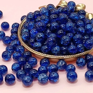 Detail shot of 10mm blue cracked glass beads in gold leaf tray for DIY jewelry making