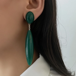 Retro emerald green water drop long earrings with gold links worn by a model