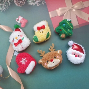 Macro view of plush Christmas brooches with embroidery details and festive sequins