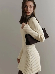Elegant cream long sleeve knit dress with brown shoulder bag and high neck A-line silhouette