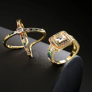 Modern 18K gold-plated crossover X ring and square zircon geometric open ring on black texture