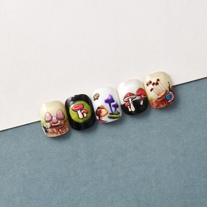 Close-up of 5D mushroom and snail embossed nail stickers with hand-painted butterfly motifs