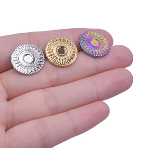Macro detail of 304 stainless steel round ear stud bases in silver, gold, and rainbow finish