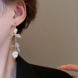 French style long petal tassel earrings with baroque pearls worn by a model