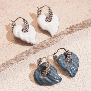 Detail of silver leaf earrings with glossy white and glittery grey-blue enamel finish