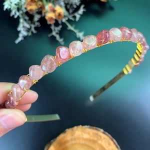 Handcrafted headband detail with pink crystals and gold wire wrapping technique