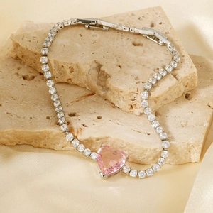 Elegant silver chain bracelet featuring a pink heart stone and sparkling white zircons