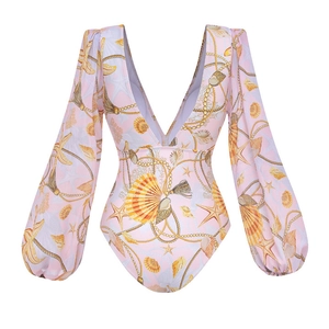 Detailed view of pink long-sleeved swimsuit with sea shell prints and bubble sleeves