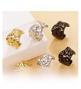 Detailed view of irregular hammered texture ear cuffs in gold, silver, and gun black finish