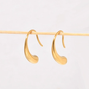 Chic 18K gold plated stainless steel teardrop earrings hanging on a wooden stand