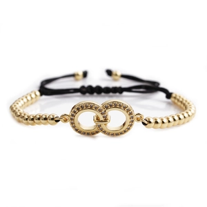 Adjustable woven bracelet with gold beads and micro-paved zircon infinity rings