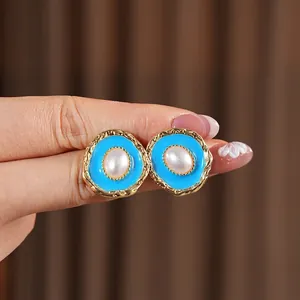 Vintage gold oval pearl drop earrings with sky blue enamel and irregular metal texture