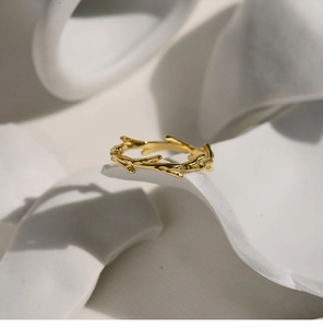 Macro view of gold plated branch shaped creative ring with natural textured finish