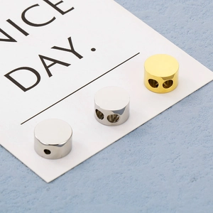 Detailed view of gold and silver cylinder metal stoppers with mirror polish and hole detail