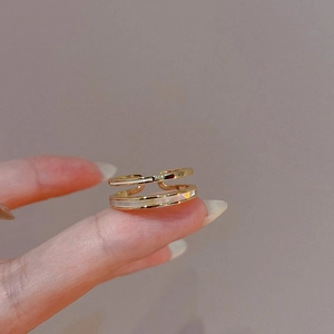 Close-up of gold-plated double-layer open ring featuring white enamel inlay details