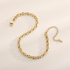 Detail of 18K gold plated stainless steel anklet featuring oval links and lobster clasp