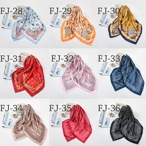 Macro view of nine satin square scarves with retro patterns and sleek silk texture