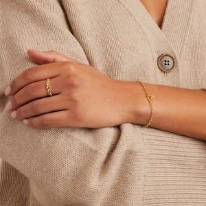 Detail of 18k gold plated heart paperclip chain bracelet and matching heart ring on model