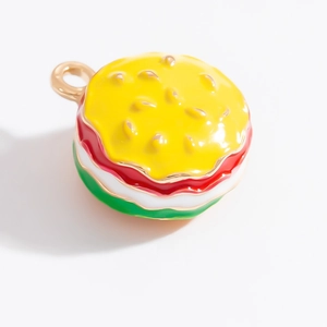 Gros plan d'un pendentif hamburger en alliage doré avec détails en émail coloré