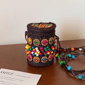 Detailed shot of handmade bohemian coconut shell woven bag with colorful beads and zip