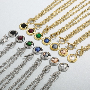 Detailed view of various crystal pendants on steel chains with toggle clasps