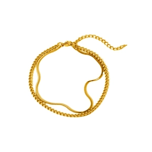Detail of gold double-layer bracelet with snake and Cuban chain links and lobster clasp