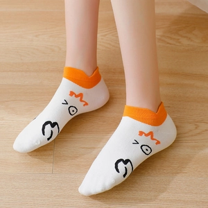 Funny white cartoon goose ankle socks with orange trim on wooden floor background