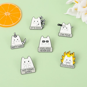 Macro shot of 6 funny white cat enamel pins with humorous slogans on a green background