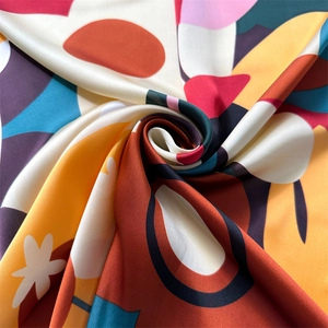 Macro shot of abstract floral print silk scarf with vibrant colors and satin texture