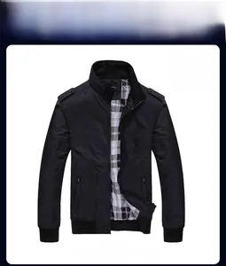 Detail view of black stand collar jacket featuring shoulder tabs and a plaid lining