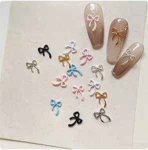 Detailed view of colorful 3D bow nail art charms in various finishes for DIY manicure