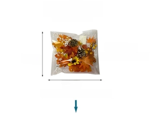 Detail showing artificial maple leaves, berries, and sunflower in a clear poly bag