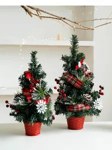 Close-up of mini Christmas trees with pine cones, red berries and plaid bows