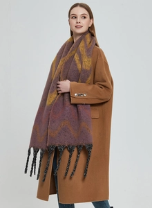 Detailed view of soft thick faux mohair scarf with purple yellow geometric pattern and tassels