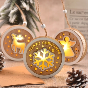 Close-up of wooden LED Christmas ornament featuring intricate reindeer cutout and warm light