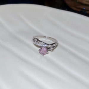 Macro shot of silver ring with pink zircon gemstone and side white diamond accents