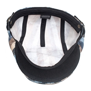 Detail view of cotton flat cap interior with black lining and 100% cotton label