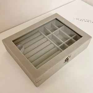 Detail of velvet jewelry box with glass lid, ring slots and secure metal clasp closure