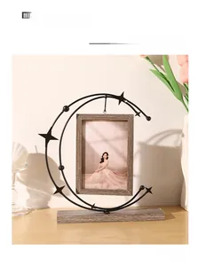 Creative moon-shaped iron picture frame with wooden base and star elements for desk decor