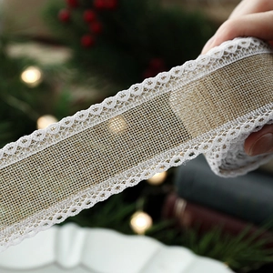 Handheld burlap lace ribbon roll for Christmas decoration with warm holiday lighting